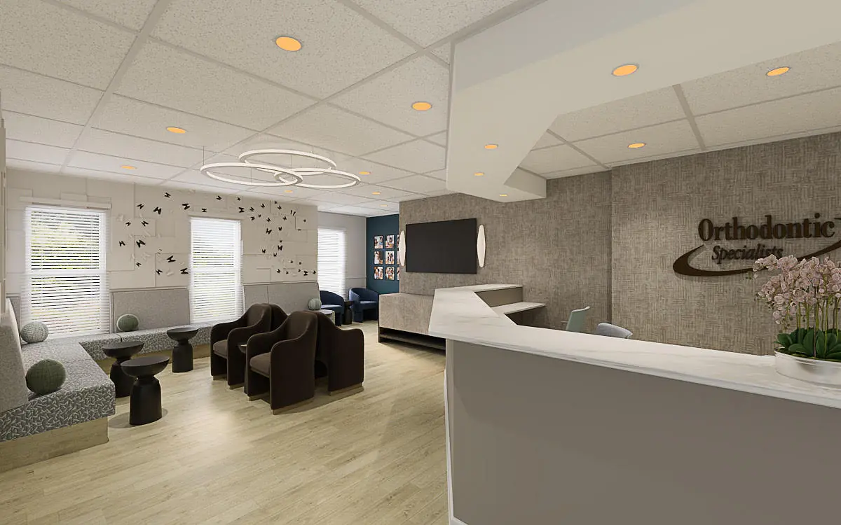 Office reception area with reception desk, dark chairs, coffee tables, wall decor, and large windows.