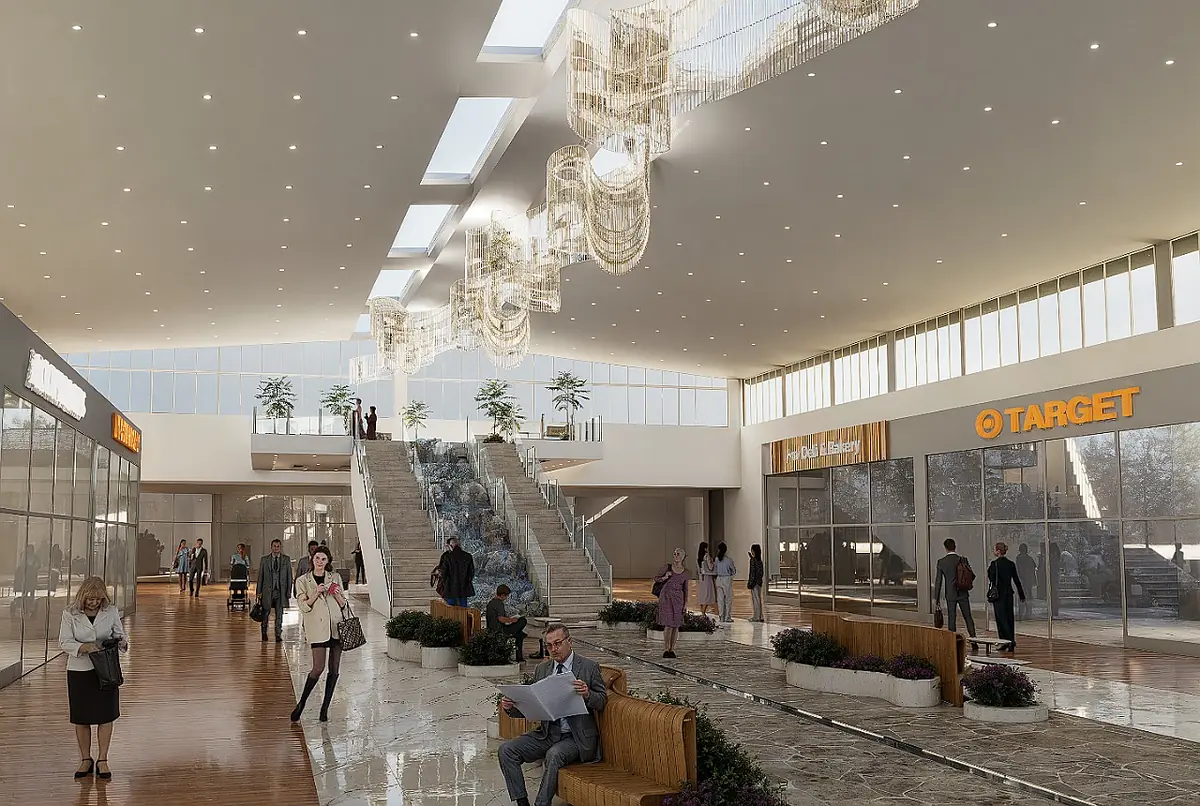 Lobby with high ceiling, glass windows, staircase, benches, plants, storefronts, and chandeliers.