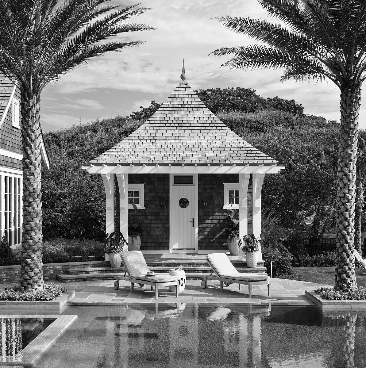 Patio with gazebo, lounge chairs, palm trees, and pool.